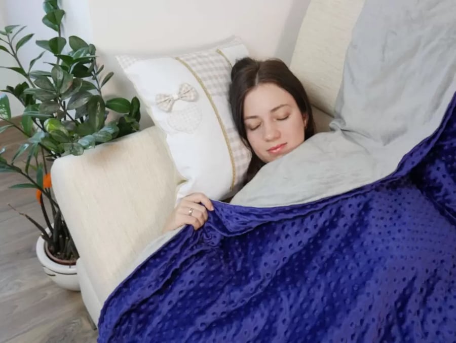 Woman sleeping with a weighted blanket for anxiety, adults and teenagers